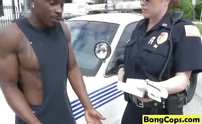 Muscled black stud fucks two busty MILF officers